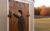 Exterior-Rampage-Door-System-on-tan-shed-with-man-opening-door
